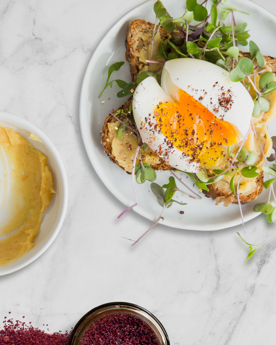 HUMMUS TOASTIE WITH SOFT BOILED EGG, PICKLED ONION, GREENS & SUMAC OIL